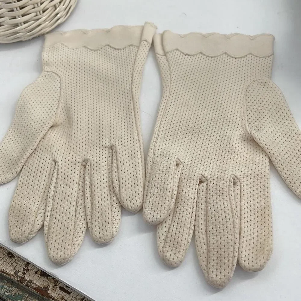 Vintage cream colored perforated gloves scalloped edges.